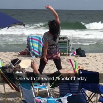 One with the wind woman does exercise on the beach