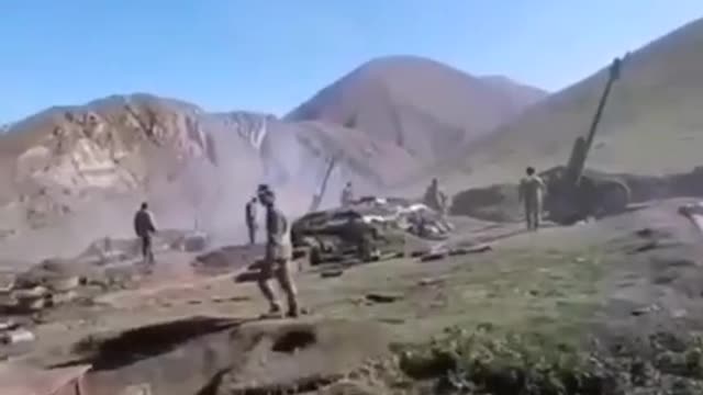 Azerbaijani artillerymen fire at Armenian positions with D-30 howitzers.