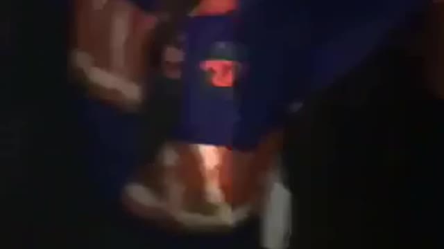 Music blue and orange jacket tries to do backflip at concert falls on back