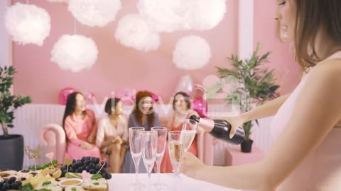 Side View Of Woman Pouring Champagne In Crystal Glasses On The Table