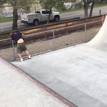 Guy black shirt skateboarding weirdly with skateboard