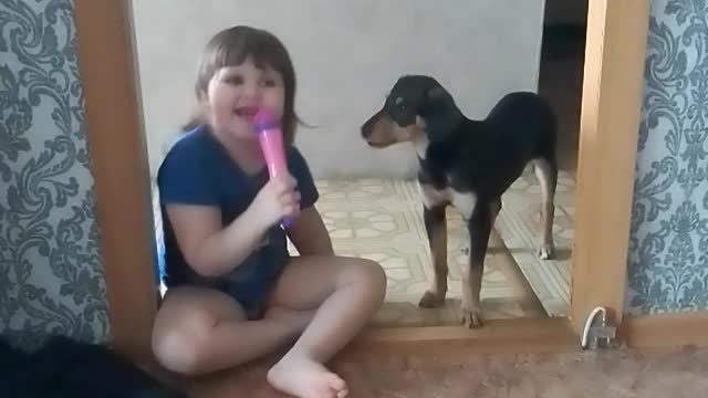 child singing with the dog