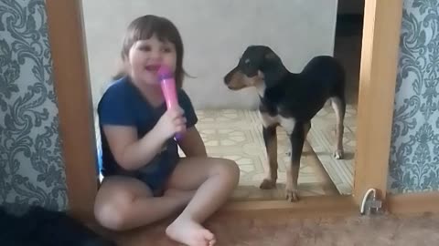 child singing with the dog