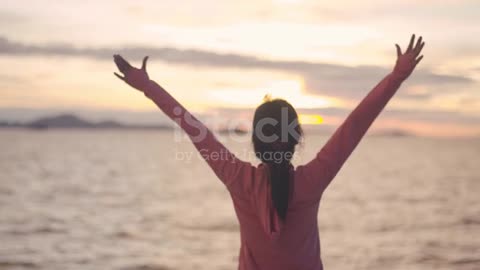 Fitness woman jogging in sportswear raises her arms in the air .