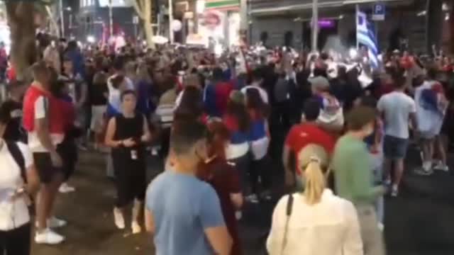 Police pepper spraying Djokovic supporters in Melbourne.