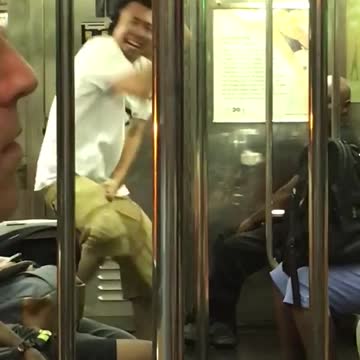 Guy black headphones white shirt khaki shorts dancing subway