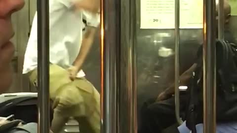 Guy black headphones white shirt khaki shorts dancing subway