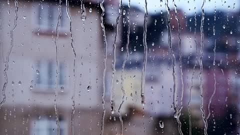 lighting up candle beside wet class during rain