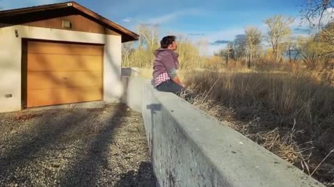 Man Sits On Wall After Performing a Front Flip