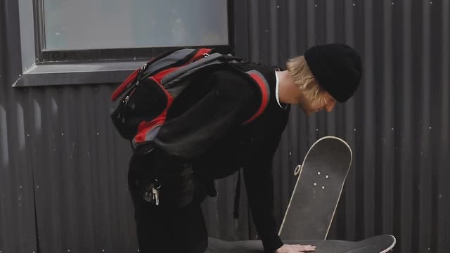 man balancing skateboard