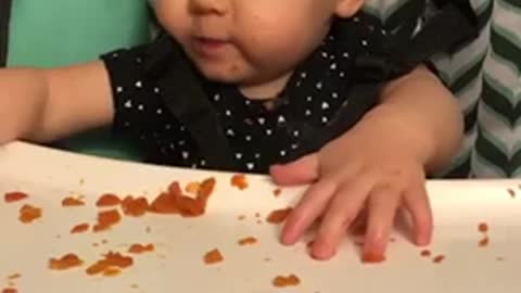 Silly baby likes to show her feet instead of eating