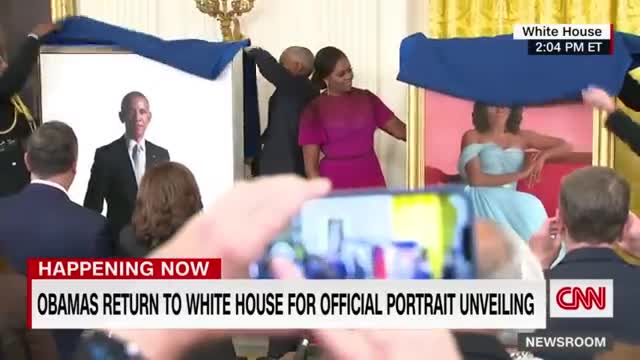 Barack Obama gives a speech after the unveiling of his White House portrait