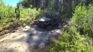 Men Riding a Jeep on a Muddy Road