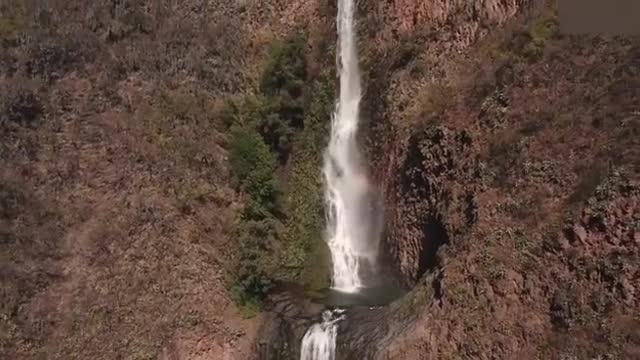 Aerial bird's eye view of cascade landscape scene shooting video