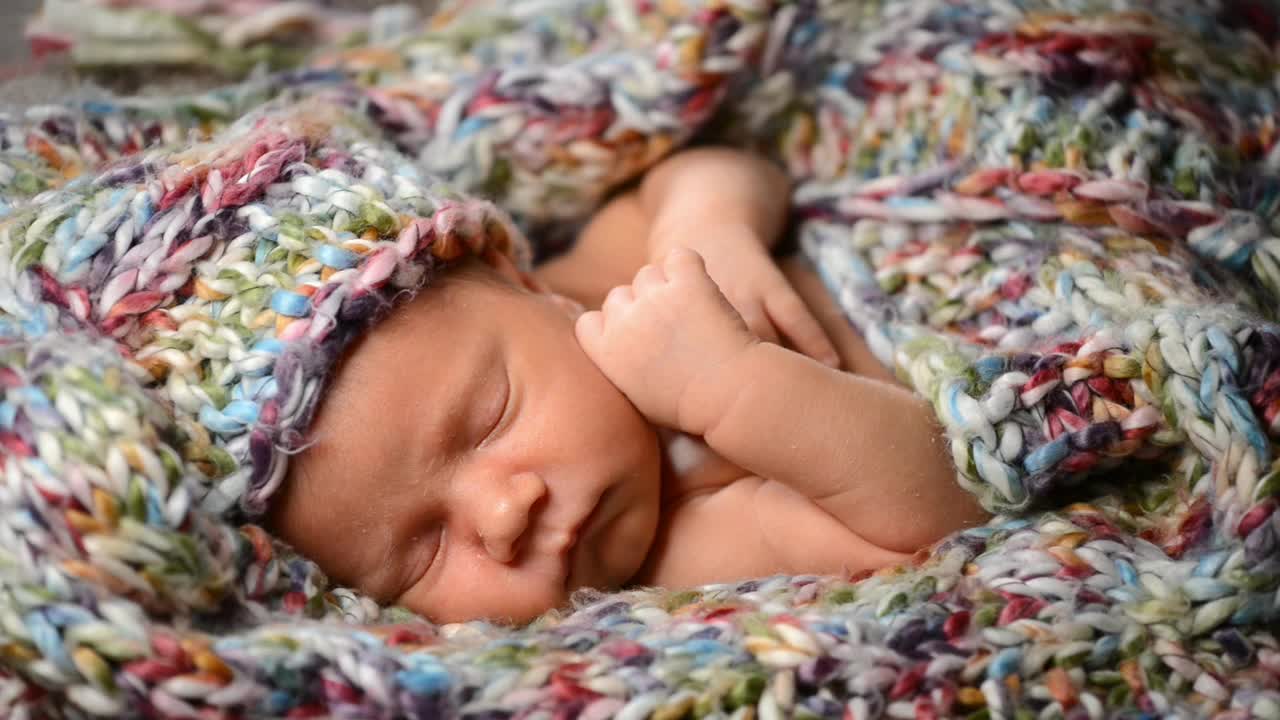 Newborn baby asleep in blankets