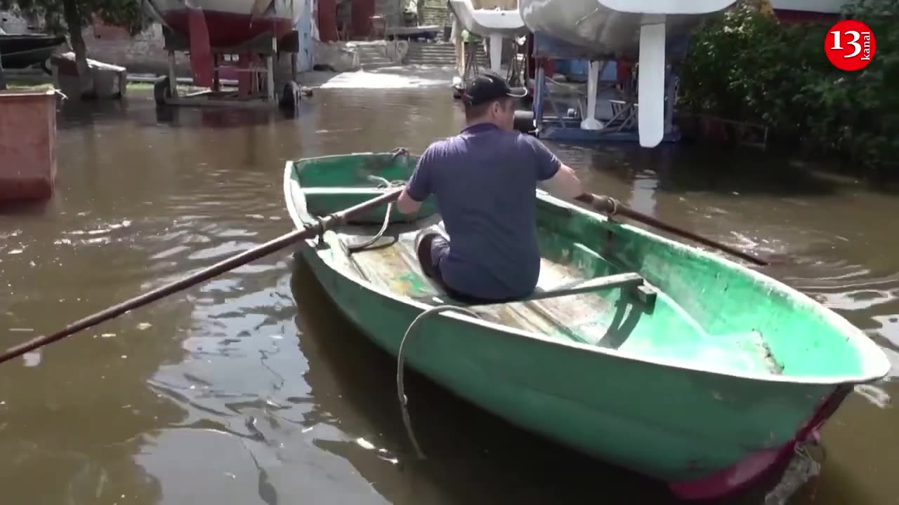 MOMENT: Man uses rowing boat on flooded streets in Ukraine's Mykolaiv