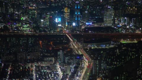 City with many cars and buildings at night