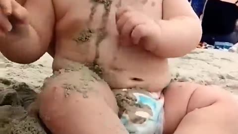 Funny baby reaction on the beach