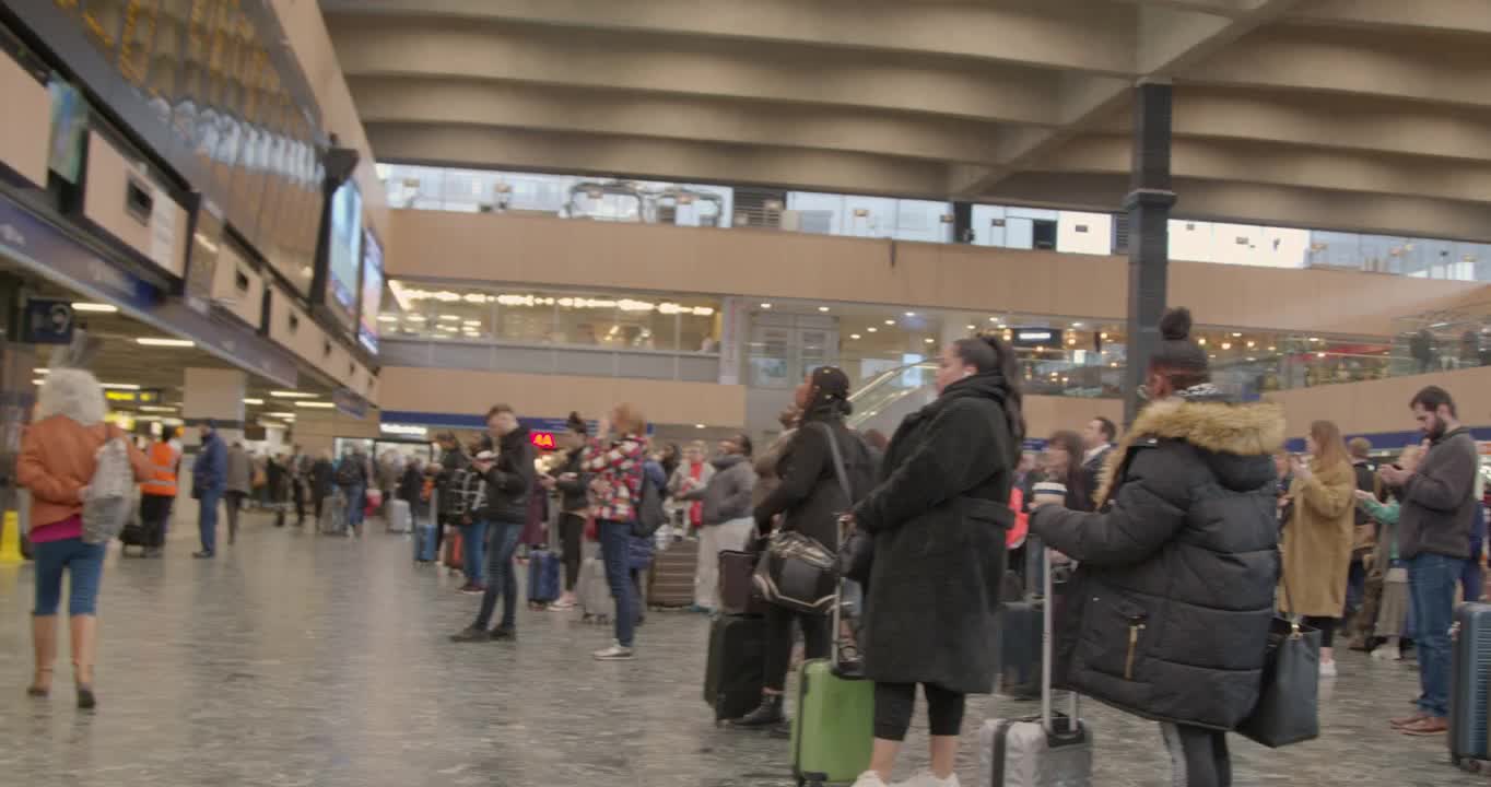 Pan of busy London Euston Train Station concourse