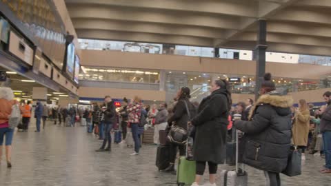 Pan of busy London Euston Train Station concourse