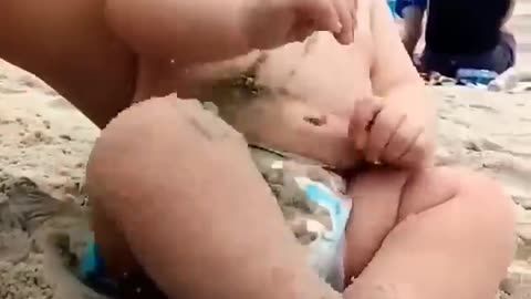 Funny baby reaction on the beach