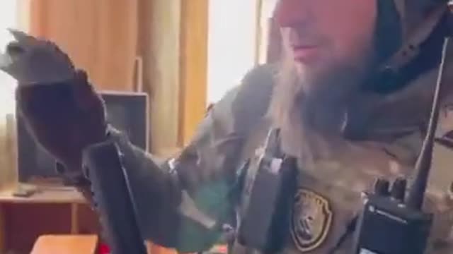 Pro- Russia Chechen fighters check captured Ukranian military ID
