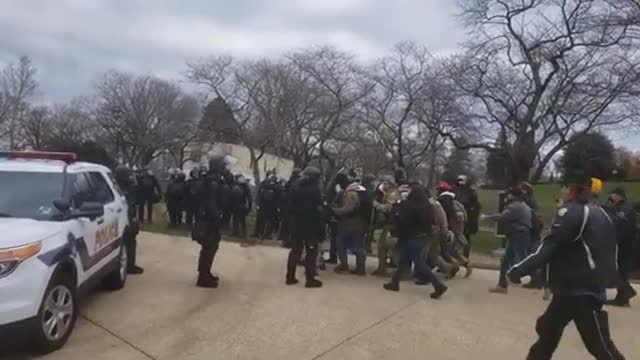 Jan 6th - Phillips Carried By Protesters Passing Standing Cops