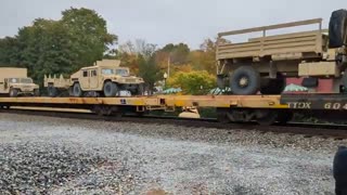 TRAIN LOADED WITH MILITARY ARMOR CARS.