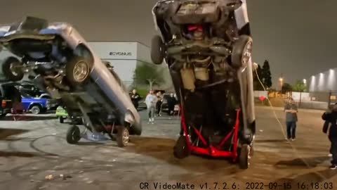 Two cars doing push-ups.