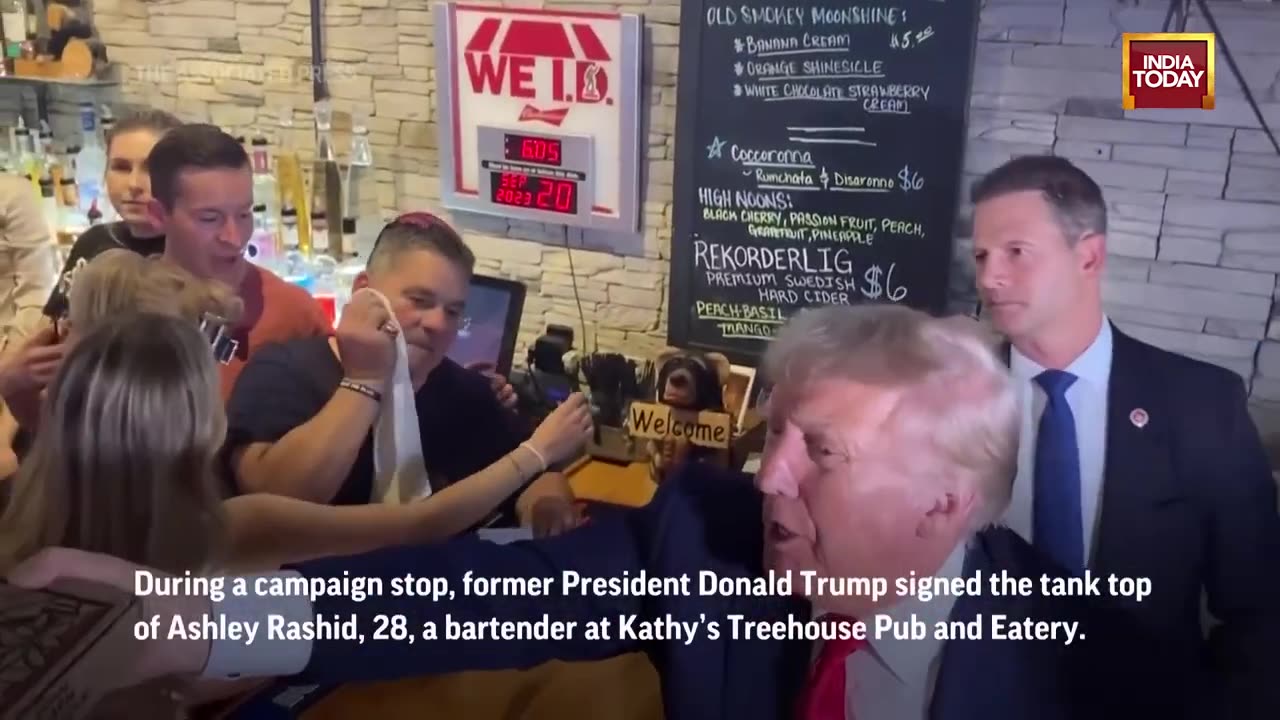 Donald Trump Autographs Woman's Tank Top During Campaign Trip In Iowa