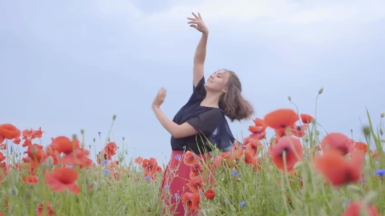 Girl dancing-happily in a field