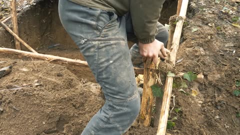 Building complete and warm survival shelter , bushcraft eart hurt grass roof and fireplace with clay