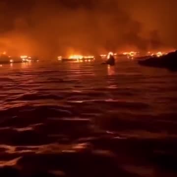 View from the harbor as fire destroys buildings in Maui