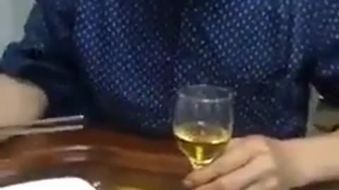 Watch a chinese man eating a live mouse at a dinner table, tomatoes seazoned!