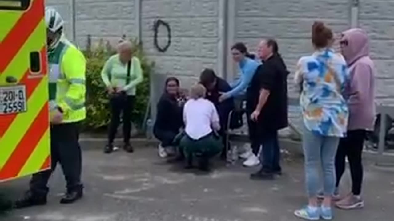 Elderly man being attended to by medical professionals after being attacked