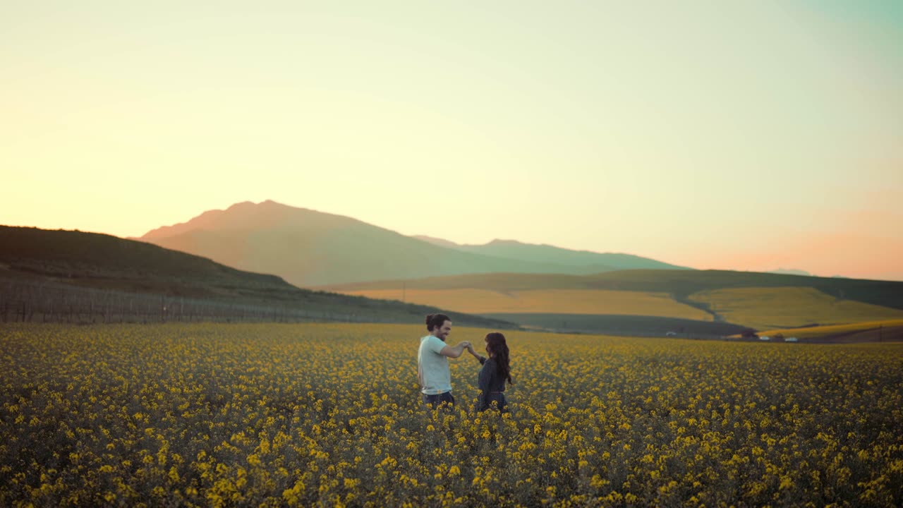 A Couple Meets And Kissed At A Middle Of A Flower Field