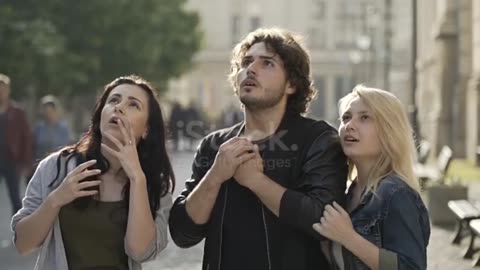 Group of friends reacting to something strange they see up high in the sky