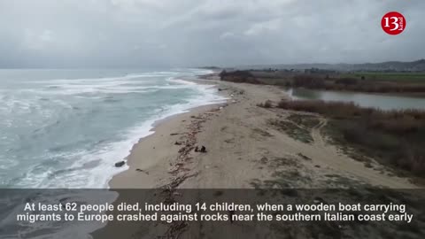 Drone footage shows debris washed up on beach following deadly migrant shipwreck