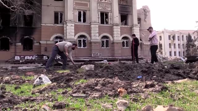 Graves and destruction seen in Mariupol as fighting rages in city