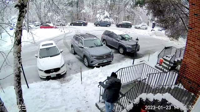 Tree Branch Comes Crashing Down While Man Shovels Snow