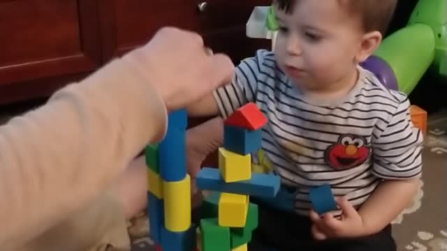 Stacking blocks with grandma.