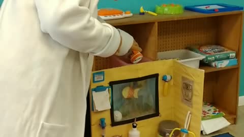 Feed the fish in the aquarium at birthday party w/ doc McStuffins at munchkins academy in Richmond