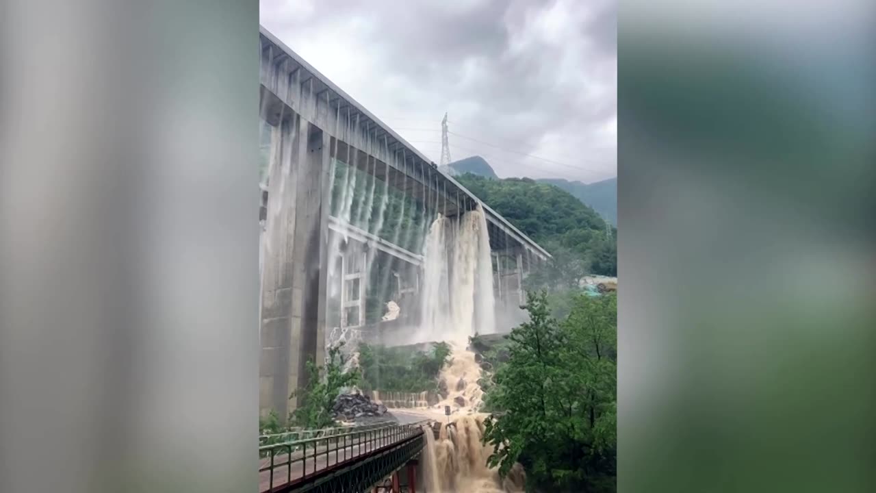 Water pours from bridges after heavy rain in China