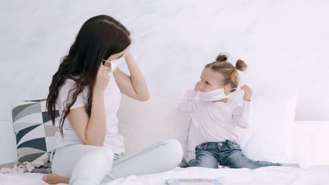 A Mother Teaching Her Kid How to Wear a Face Mask