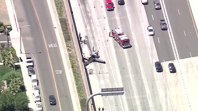 Plane crash lands on California highway, catches fire