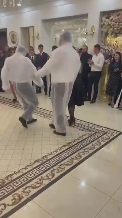 Taking it to the next level of stupidity with covid protection outfits warn at a wedding