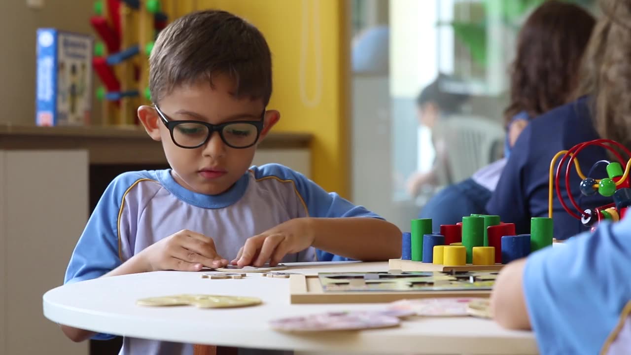 Boy trying to put puzzle together