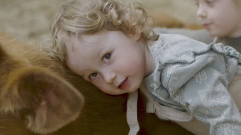 Cute baby is showing her love to animals