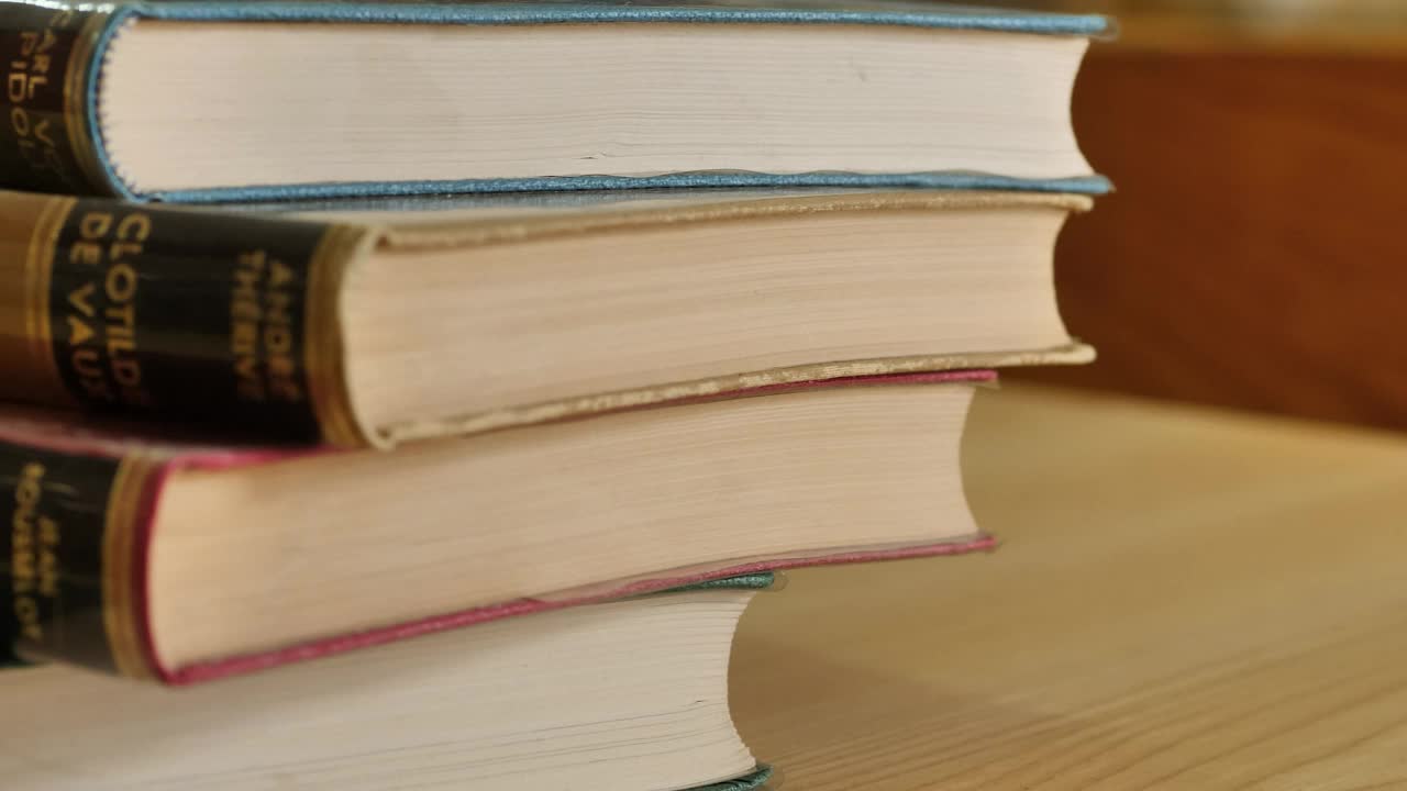 Thick old stacked books viewed in detail