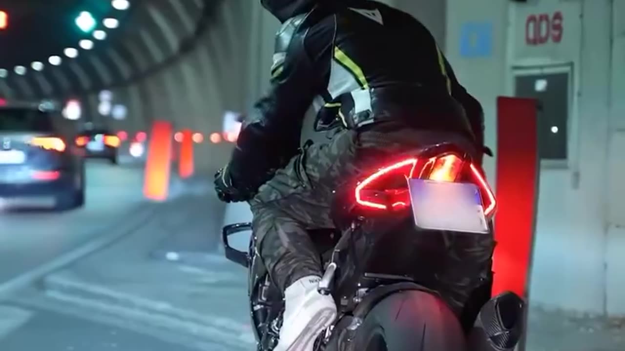 A wireless carbon fiber helmet with LEDs mirroring a motorcycle's brake lights and turn signals enhances visibility significantly